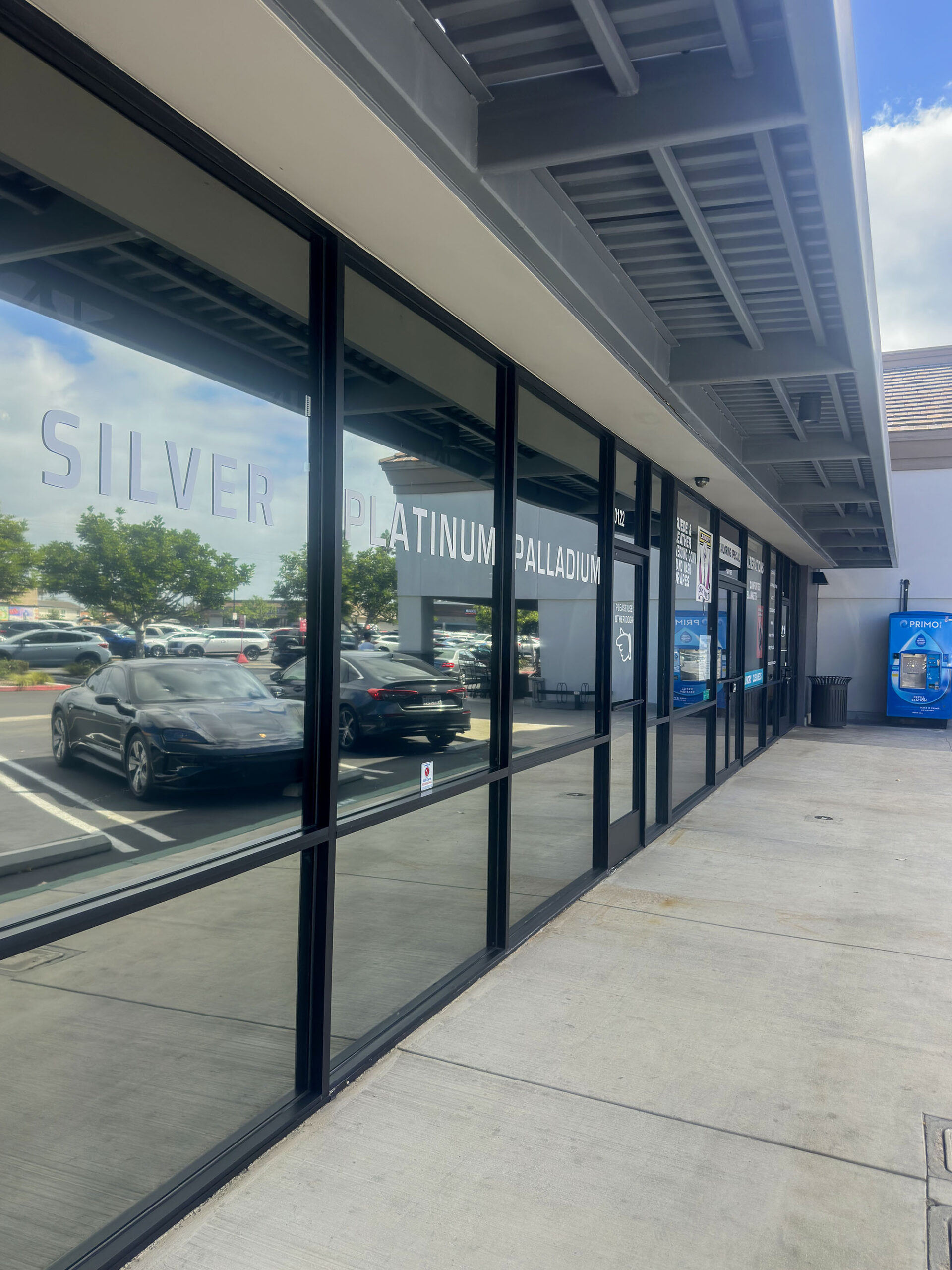 Commercial Storefront Window Cleaning – Huntington Beach Long row of freshly cleaned commercial storefront windows at Liberty Coin in Huntington Beach.